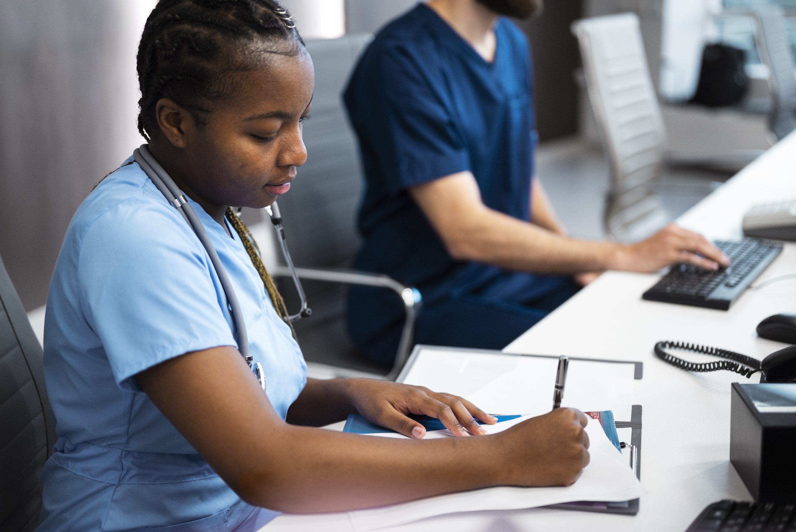 A nurse working at a desk.